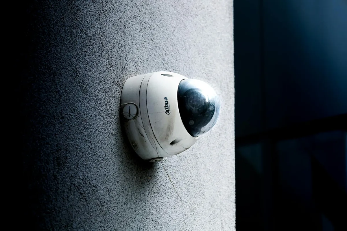 A modern outdoor security camera mounted on an exterior wall